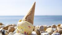 melting ice cream cone on rock beach